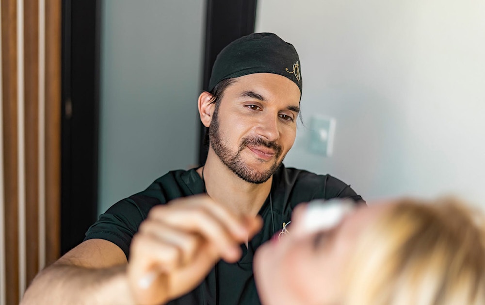 Dr. Shah looking at a patient's nose