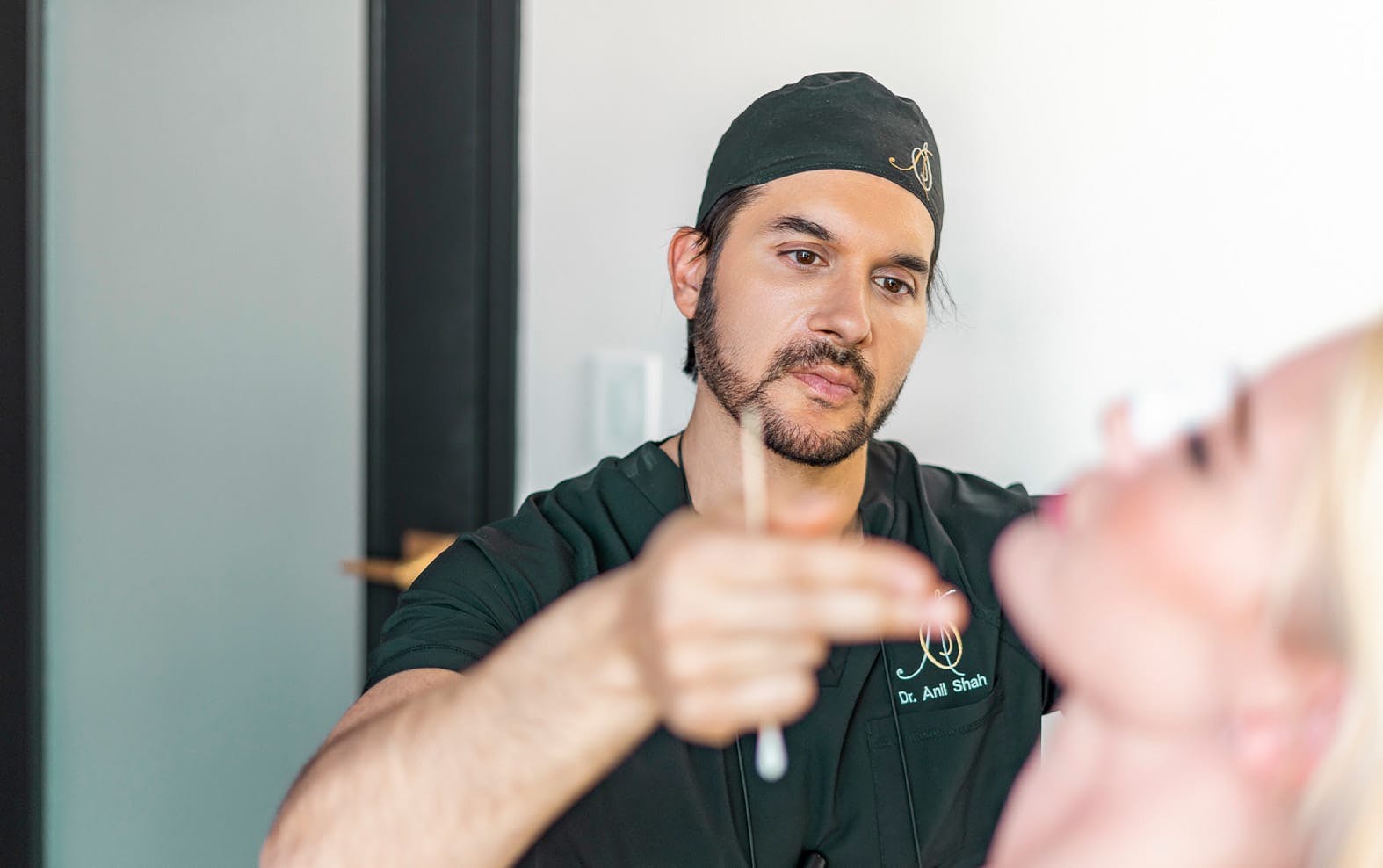 Dr. Shah looking at a patient