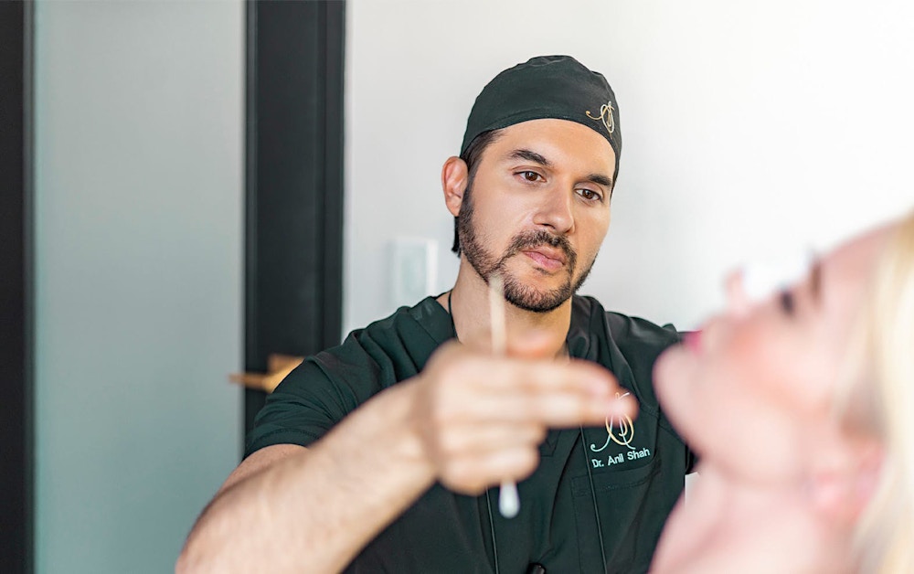 Dr. Shah looking at a patient