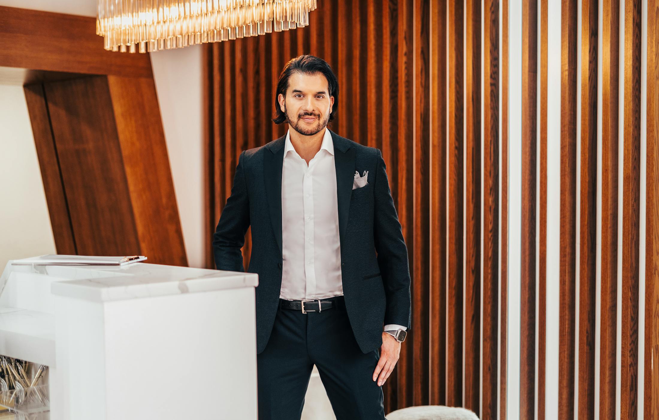 Dr. Shah standing by white desk