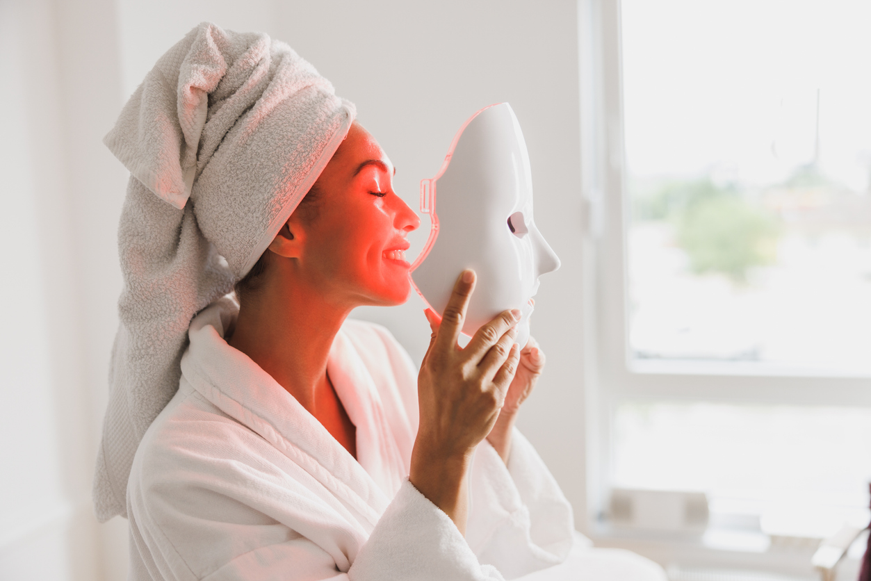 Woman using an at-home red LED face mask