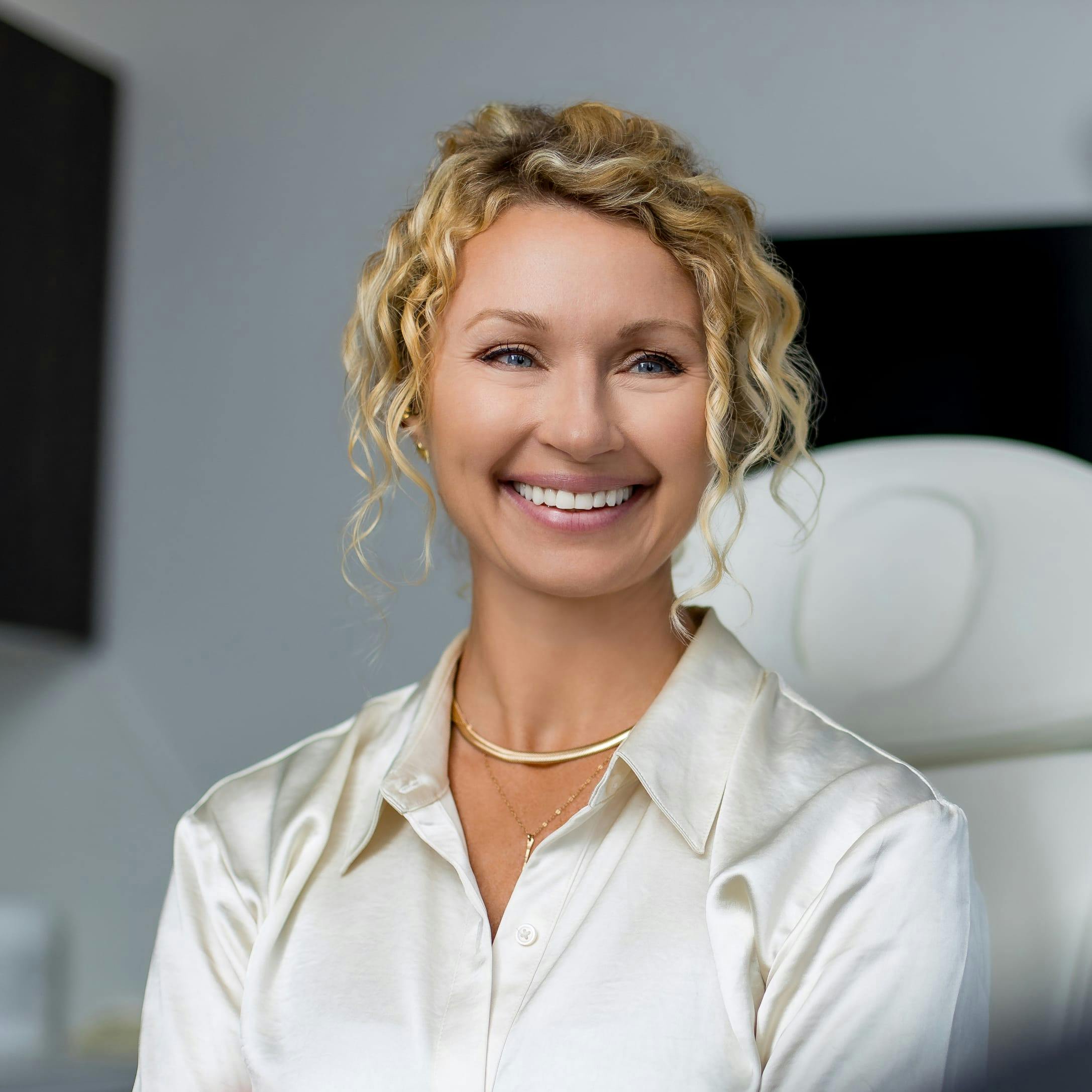 Woman in a patient chair, smiling