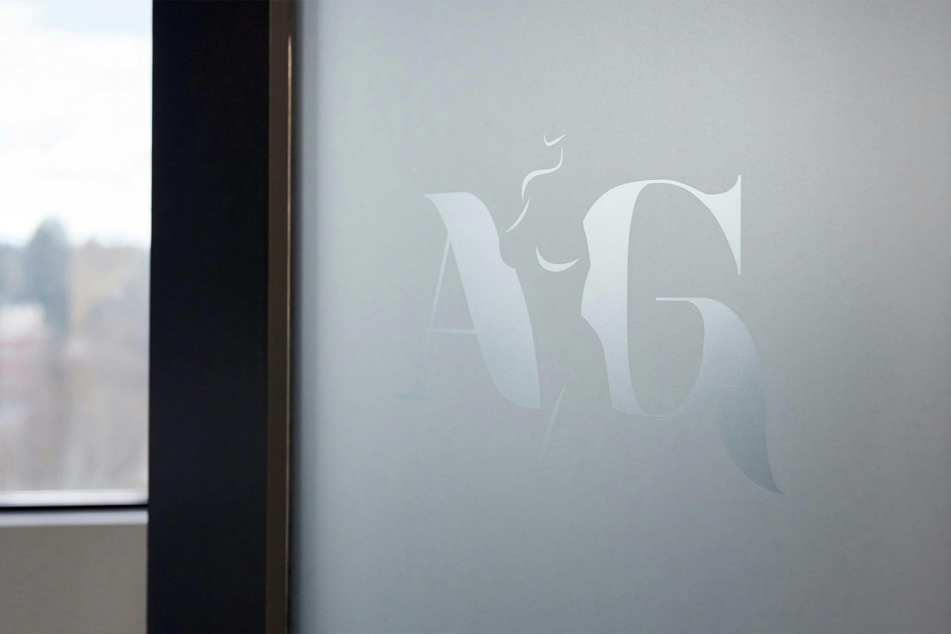 AG Aesthetics logo on glass