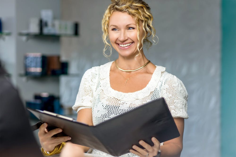 Woman smiling with clipboard