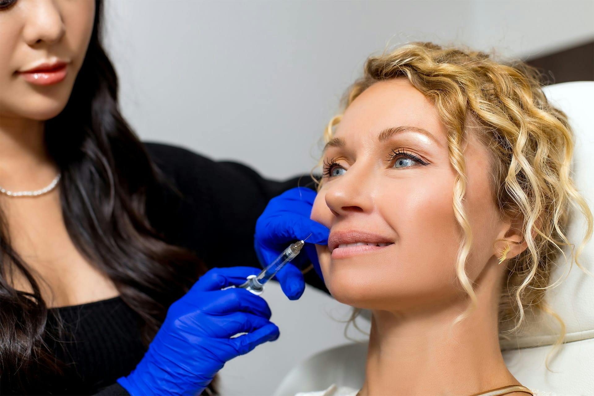 Woman receiving lip injection