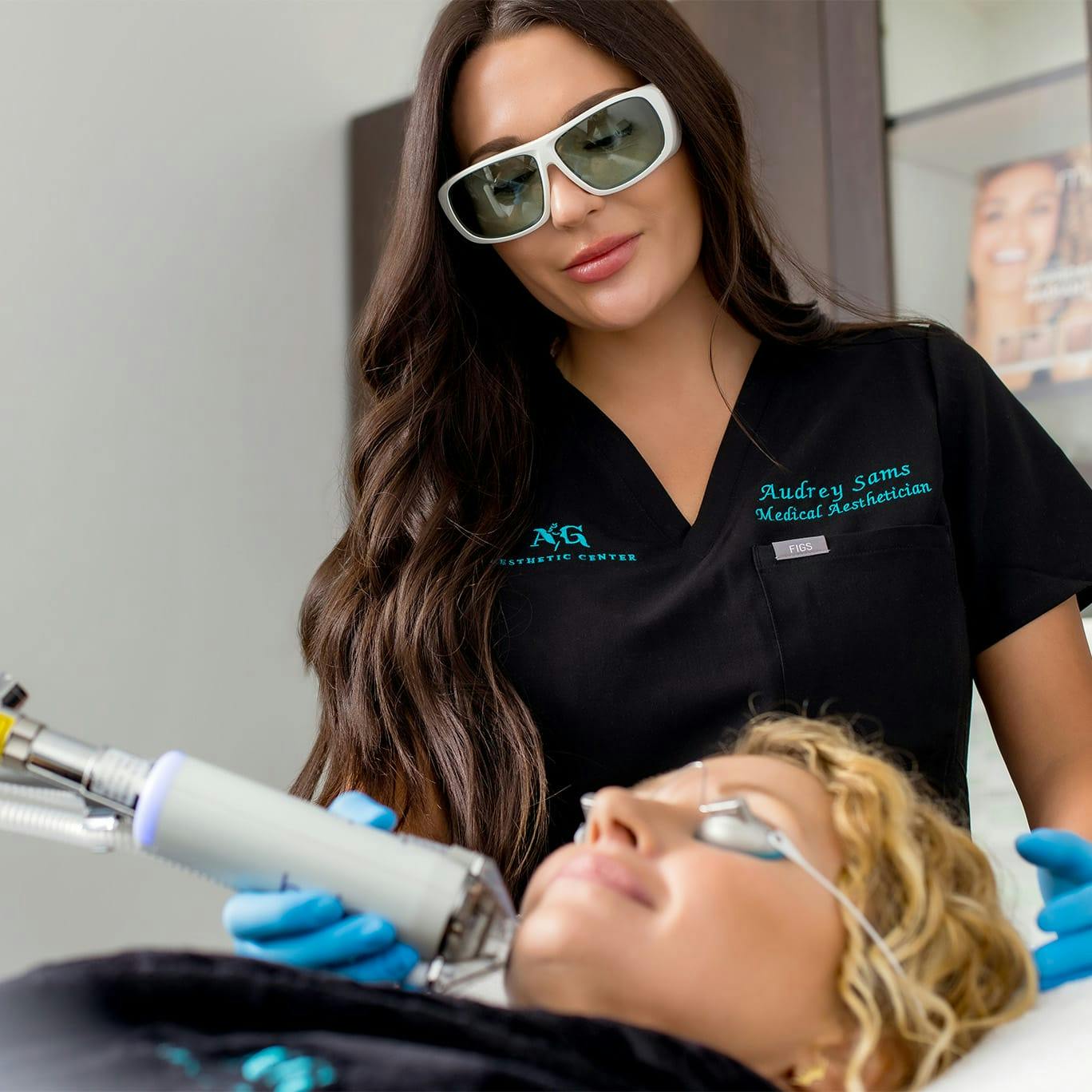 Audrey administering laser facial