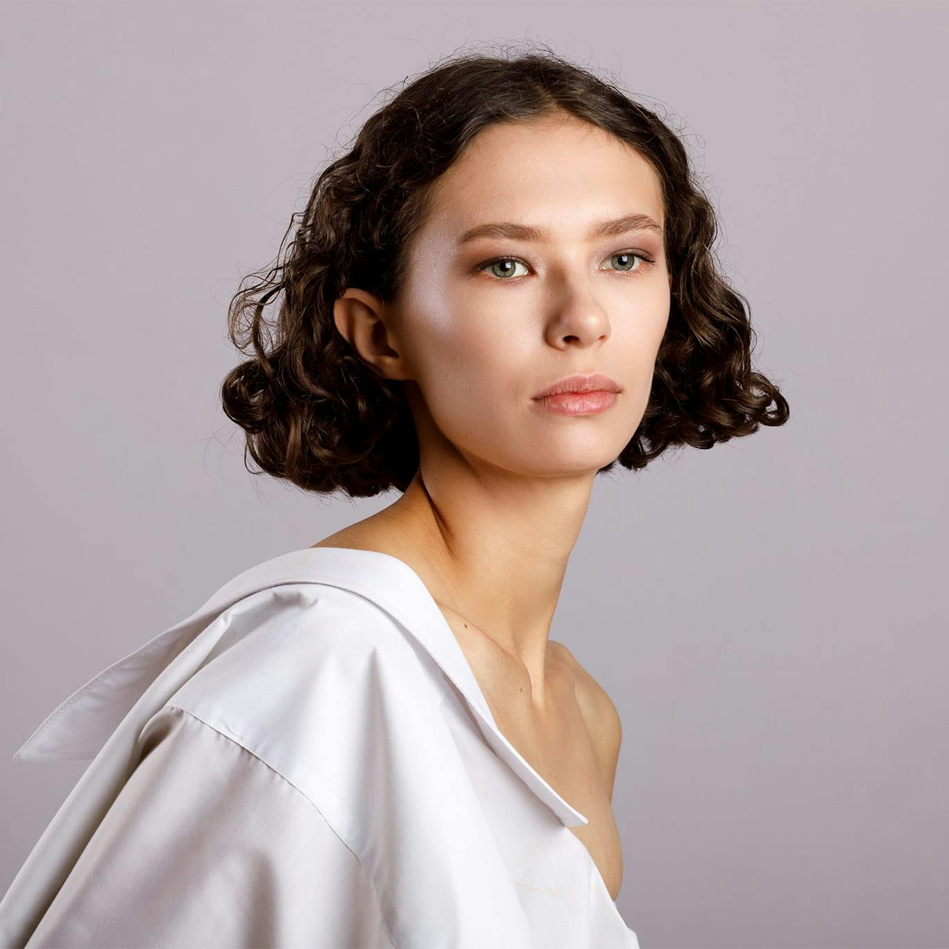 Woman with shirt draped over shoulder