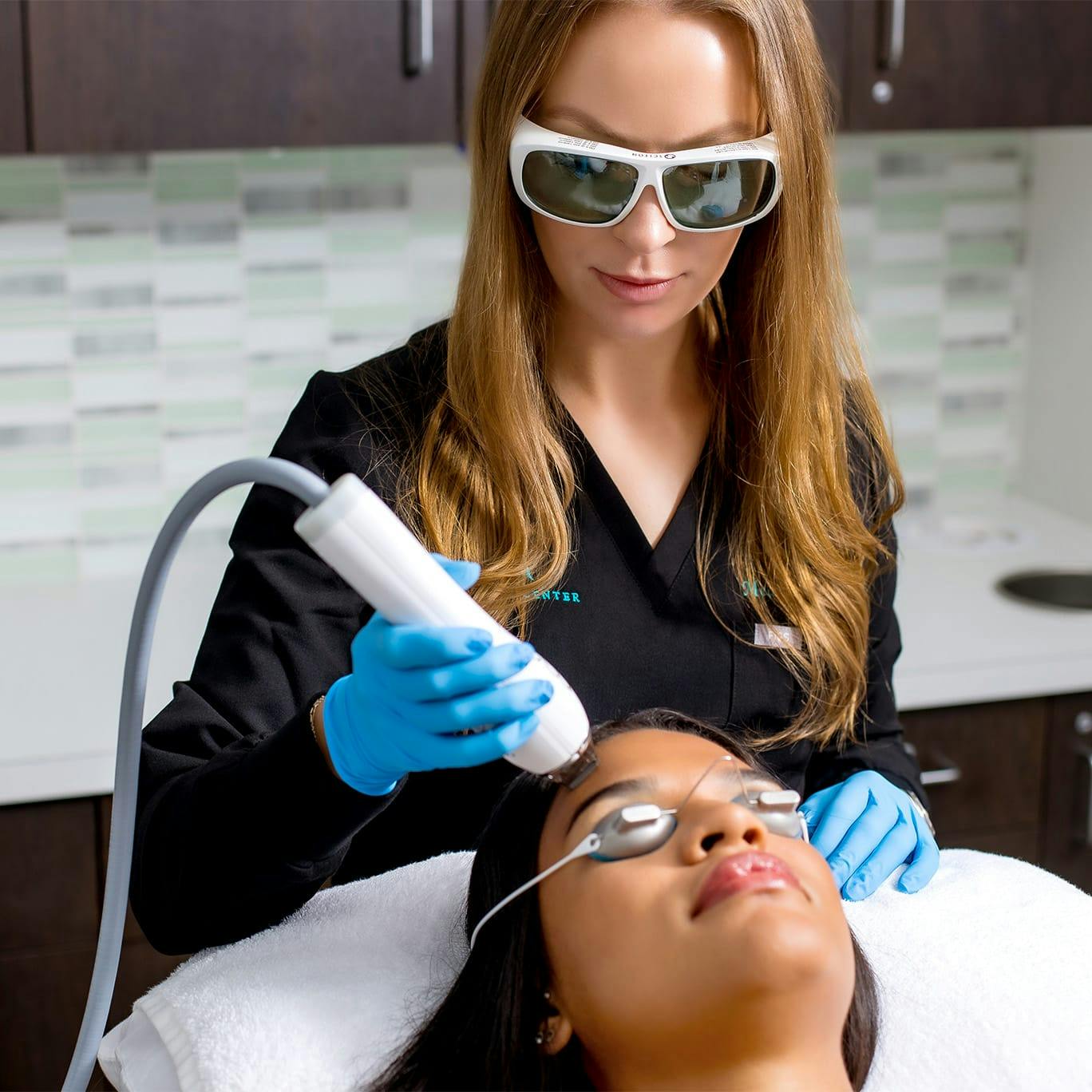 Practitioner administering MOXI laser