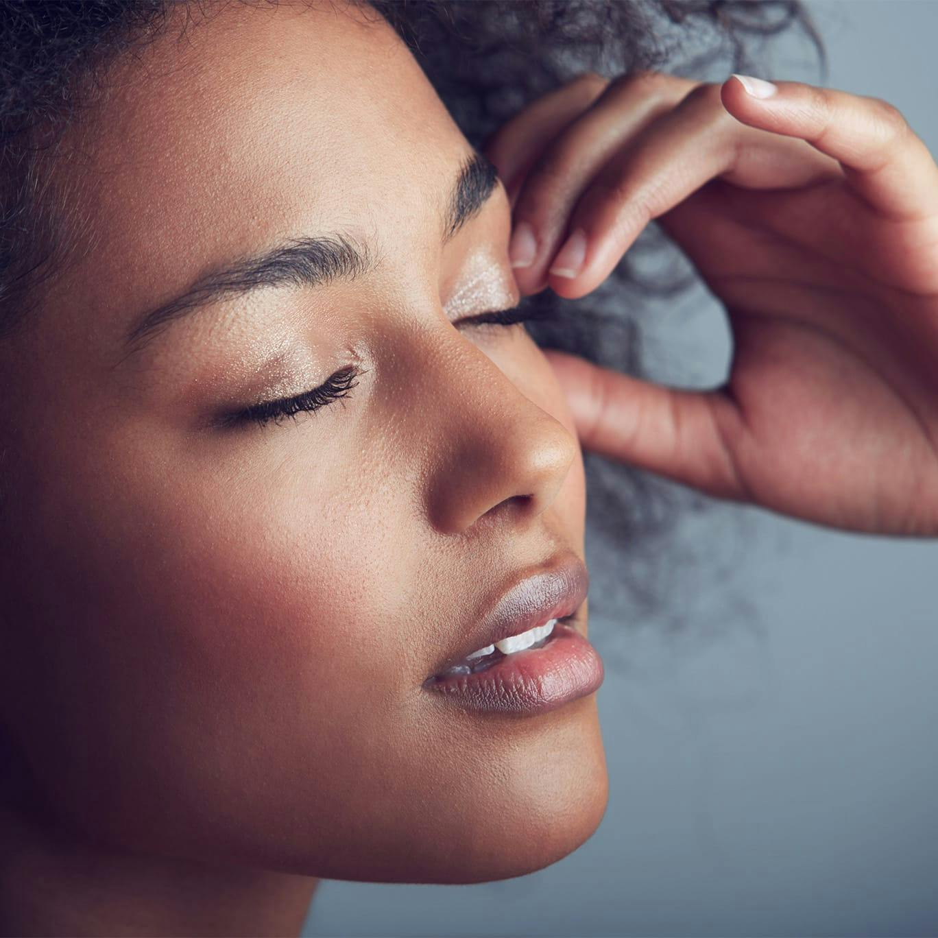 Woman resting hand on forehead