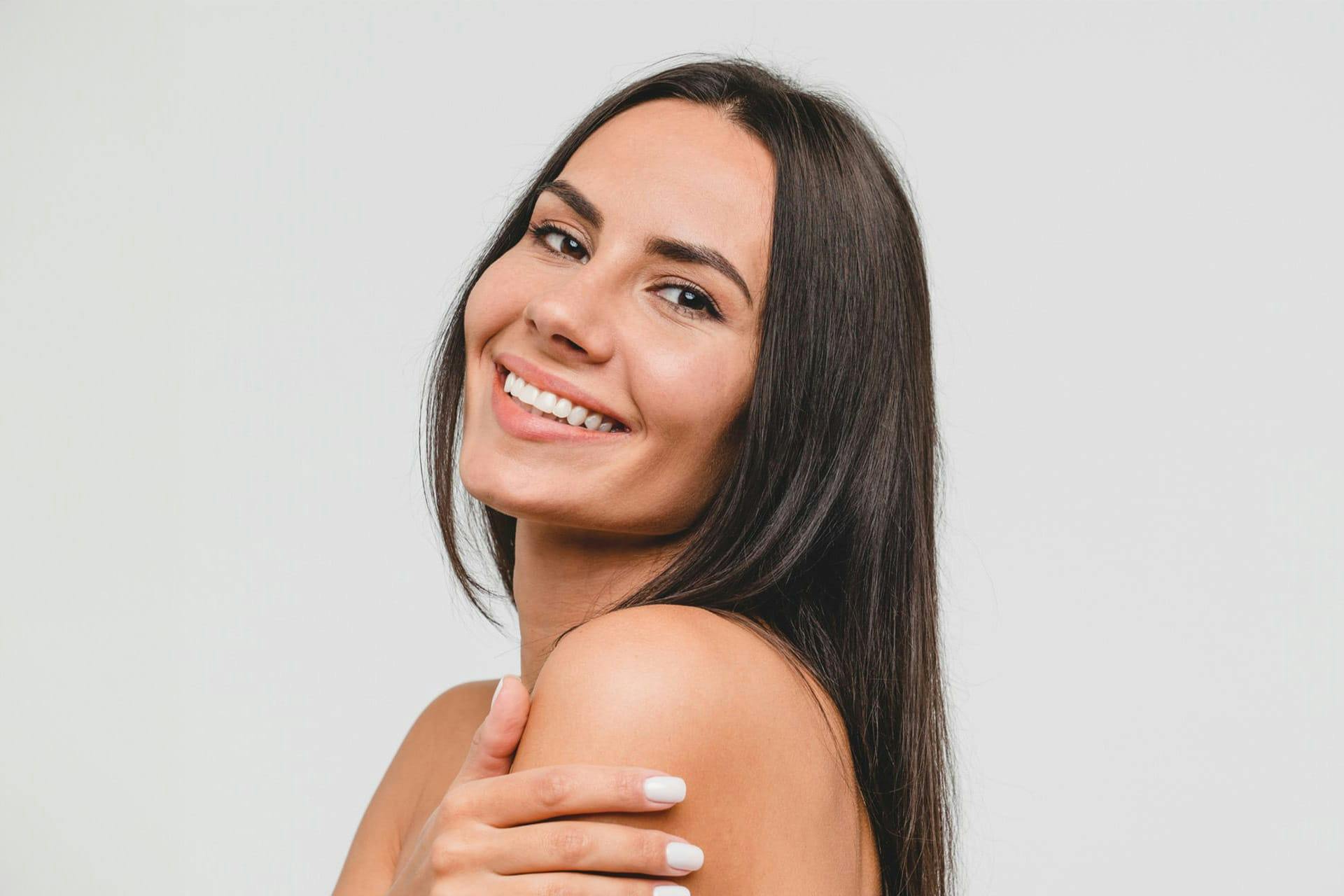 Woman smiling over shoulder