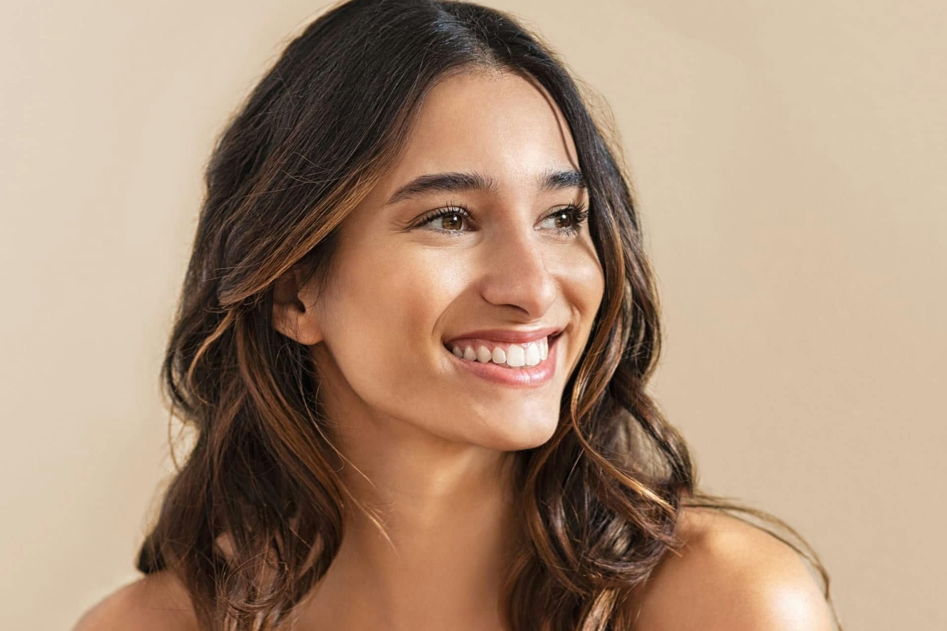 woman with brown curly hair smiling