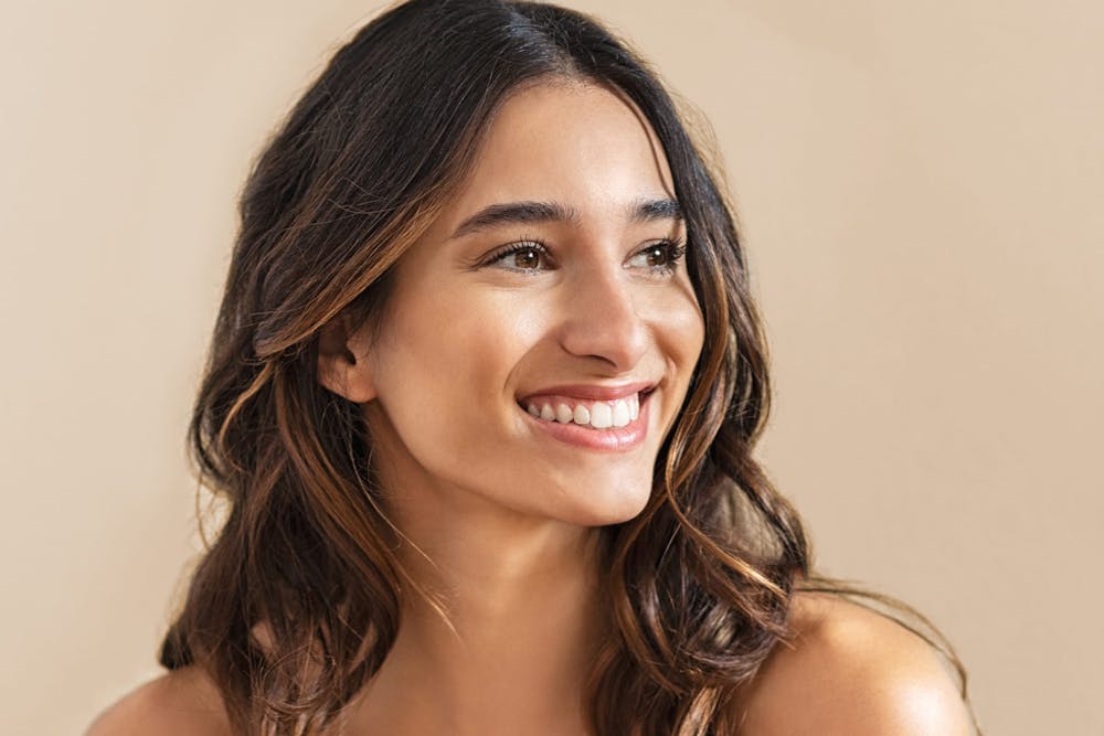 woman with brown curly hair smiling
