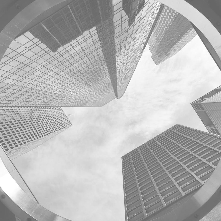 greyed out photo of looking up at sky scrapers and sky