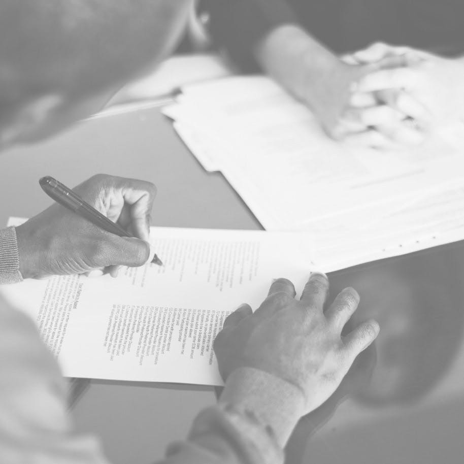 man signing documents