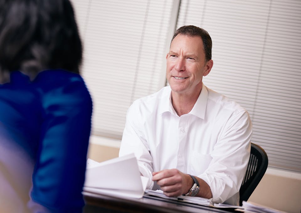 Douglas N. Silverstein smiling at desk