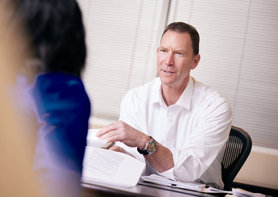 Douglas N. Silverstein showing a document to a client