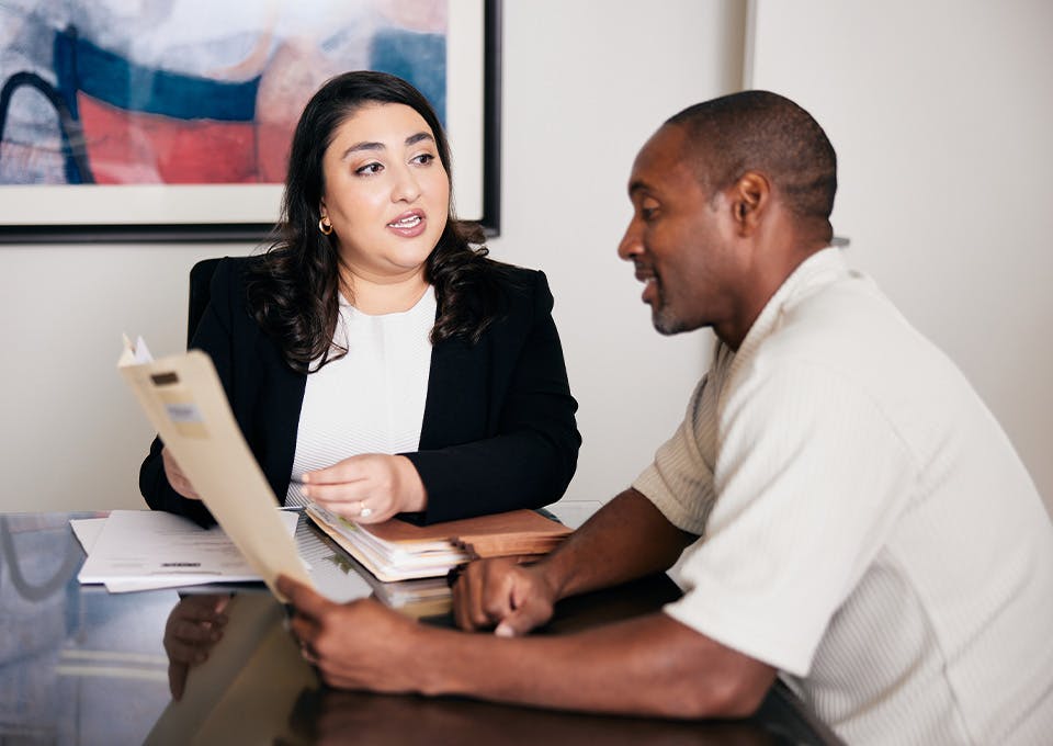Niki Akhaveissy speaking with a client