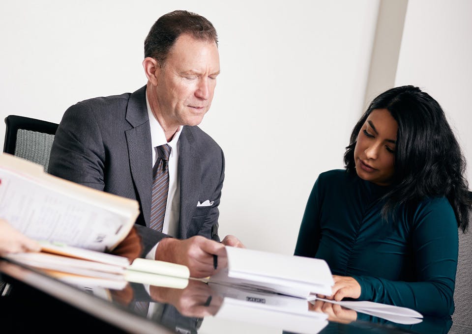 attorney and woman looking at documents