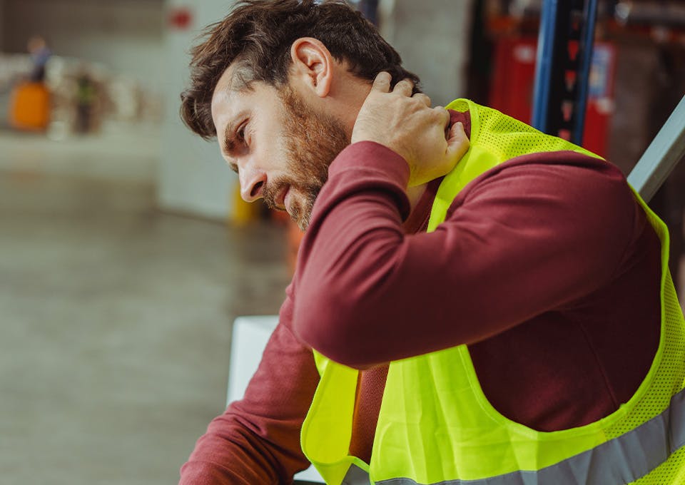 construction worker touching neck