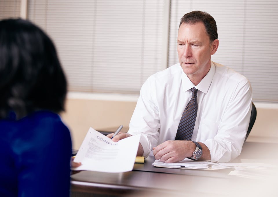 Douglas N. Silverstein handing client a document