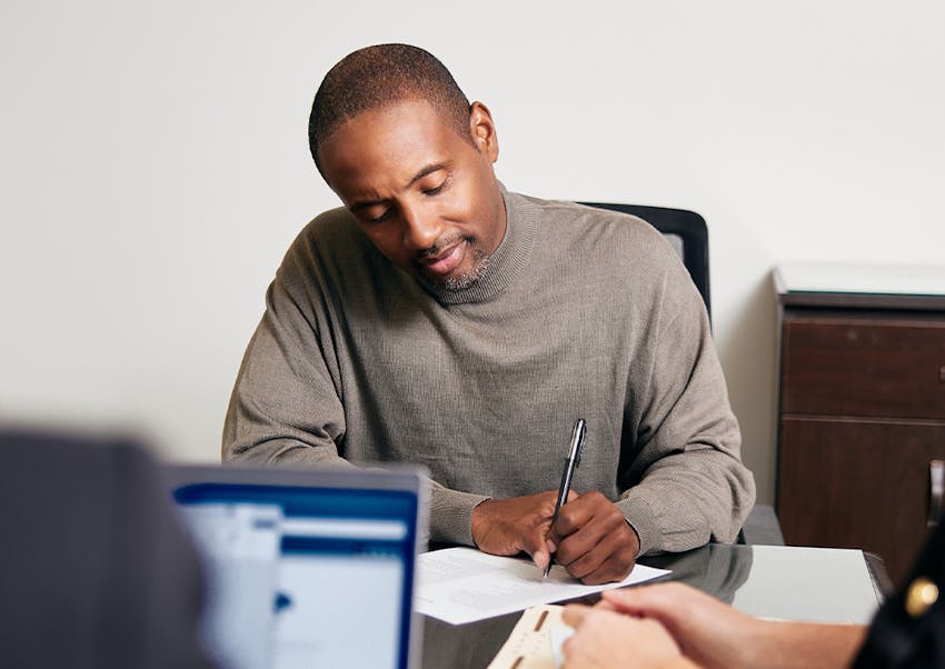 a man signing a document