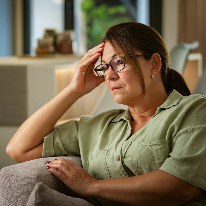 a woman thinking and touching her head
