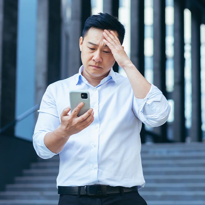 stressed man looking at phone