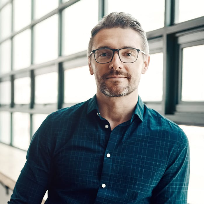 a man wearing glasses and a button down shirt