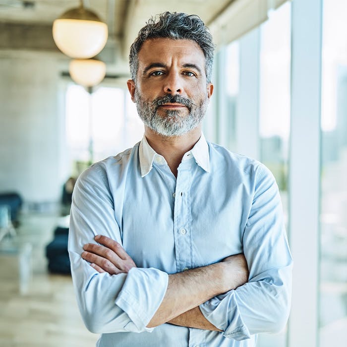 an older man with arms crossed