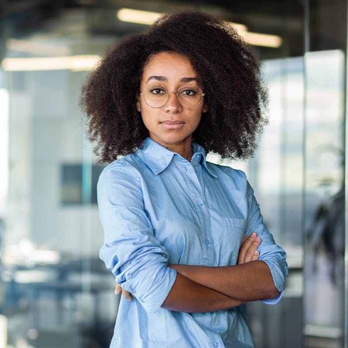 woman with button down and arms crossed
