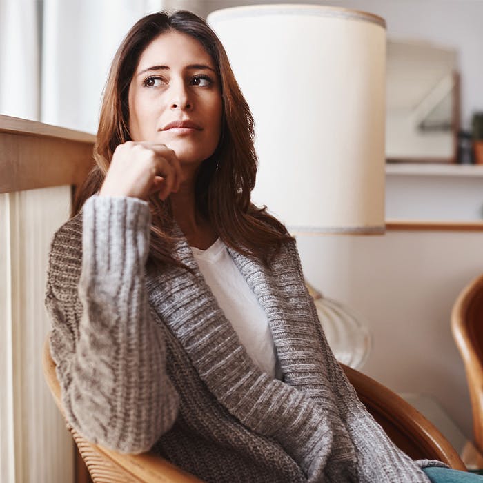 woman staring right sitting in a chair