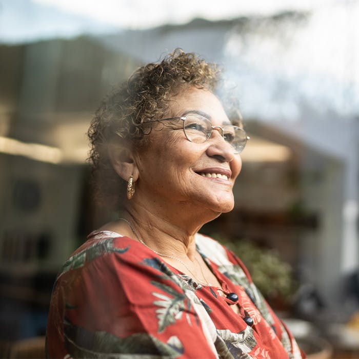 older lady smiling looking out window