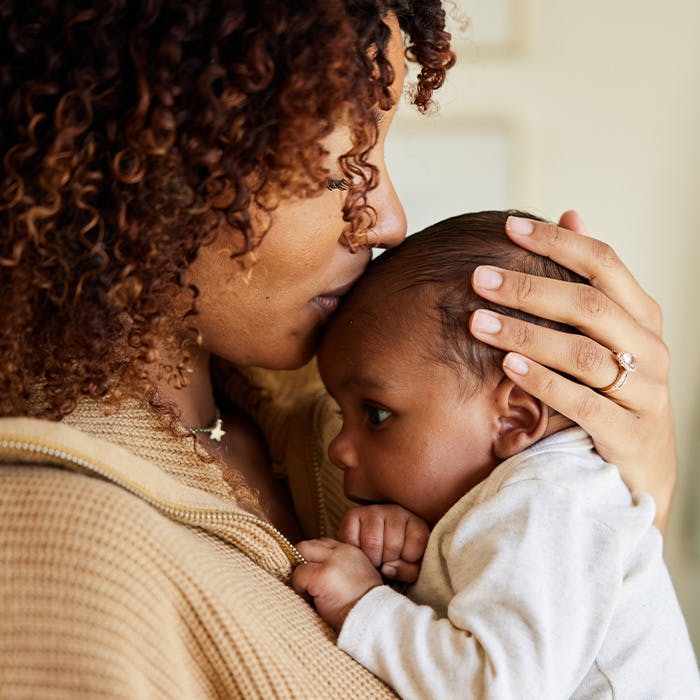 mother kissing her baby's head