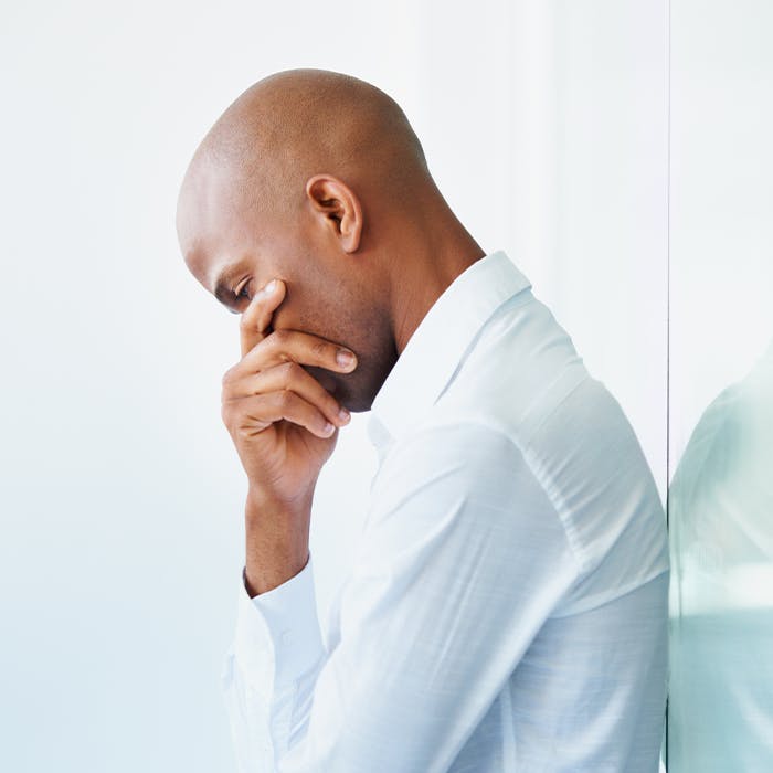 A man covering his face