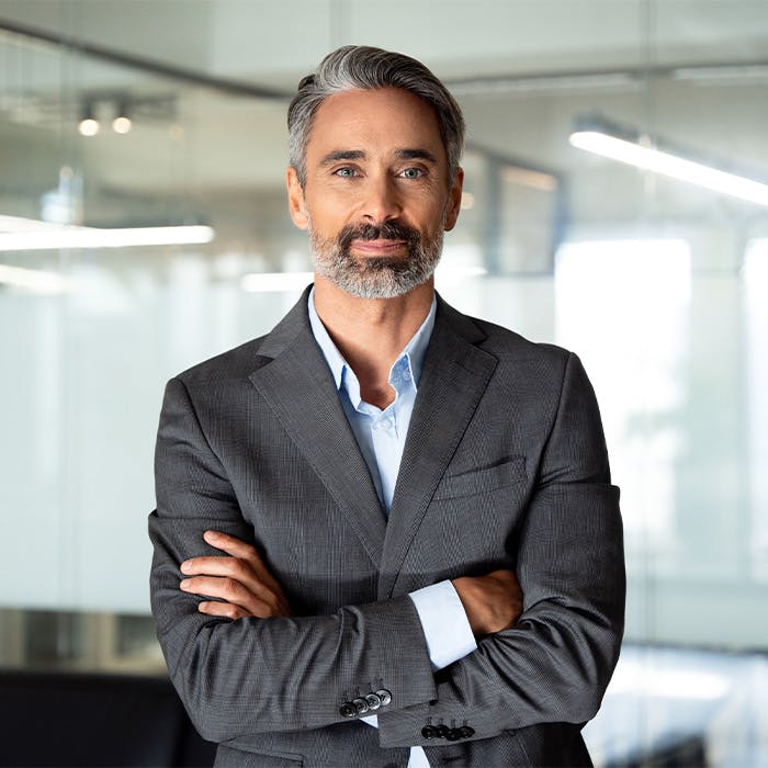 man in suit with arms crossed