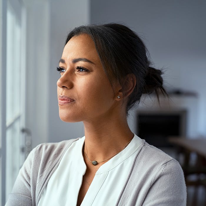 woman staring out window