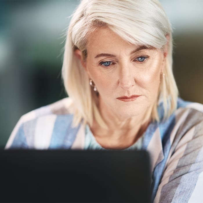 older woman looking at laptop screen