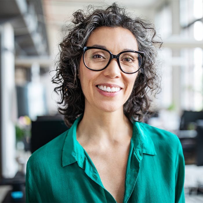 a woman wearing glasses smiling