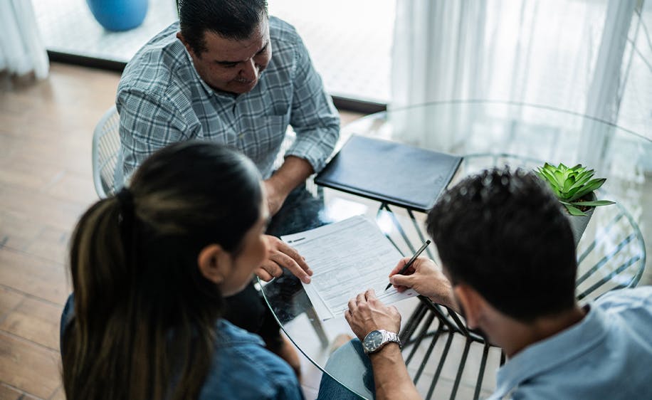 Three individuals working at a table