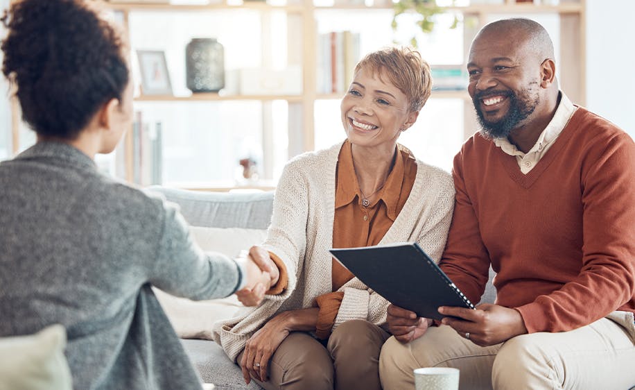 A couple speaking with an attorney