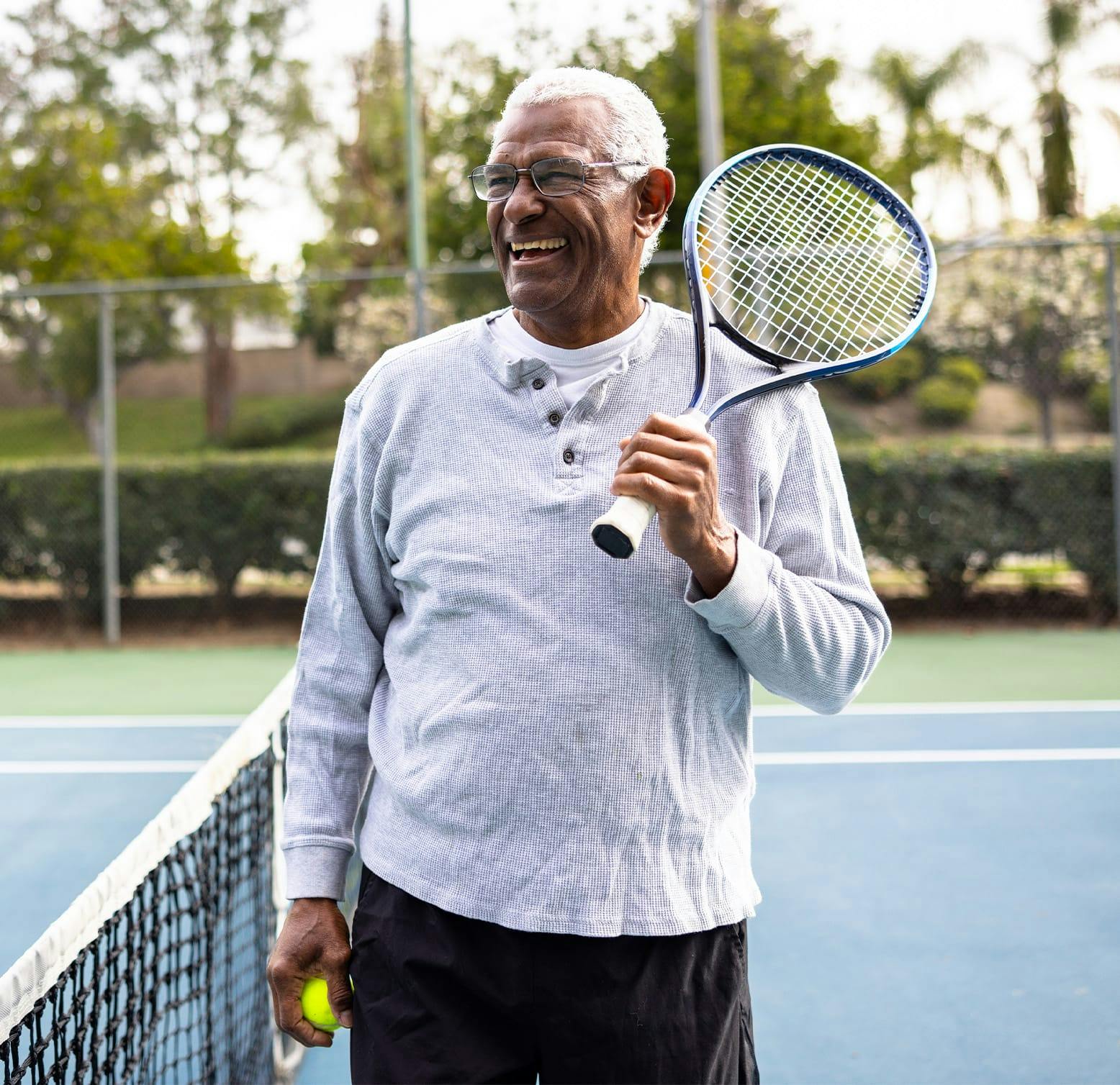 older man holding a tennis racket