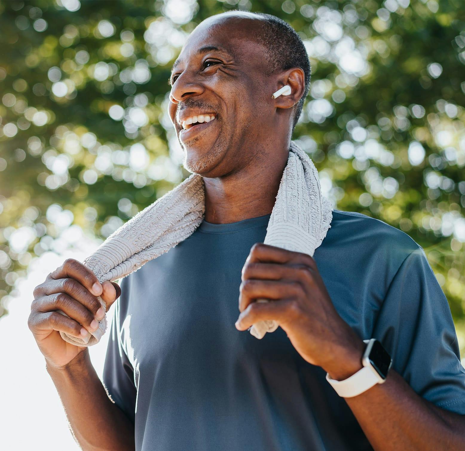 smiling man with a towel on his shoulders
