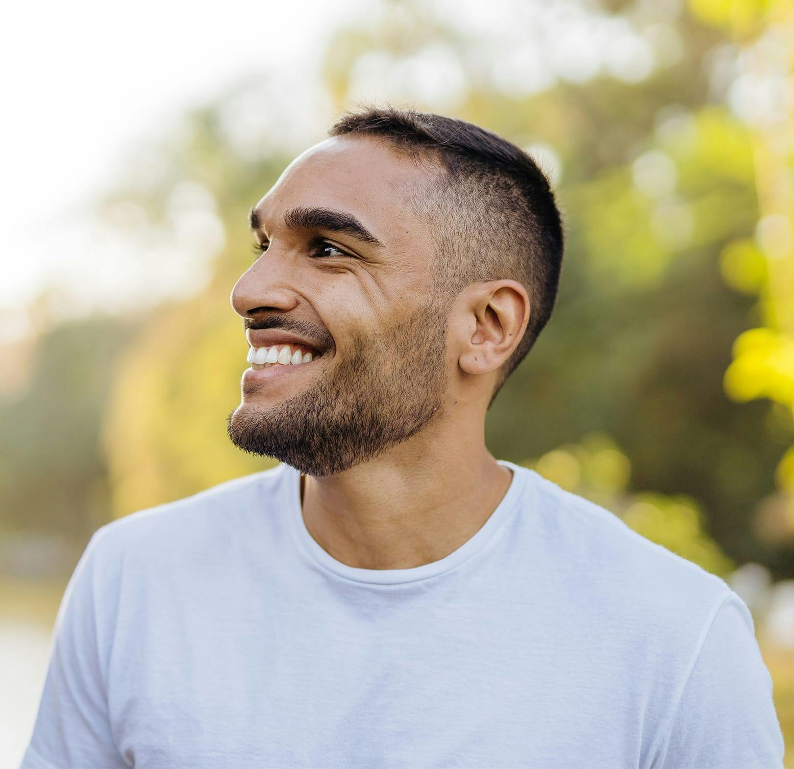 man smiling, looking left