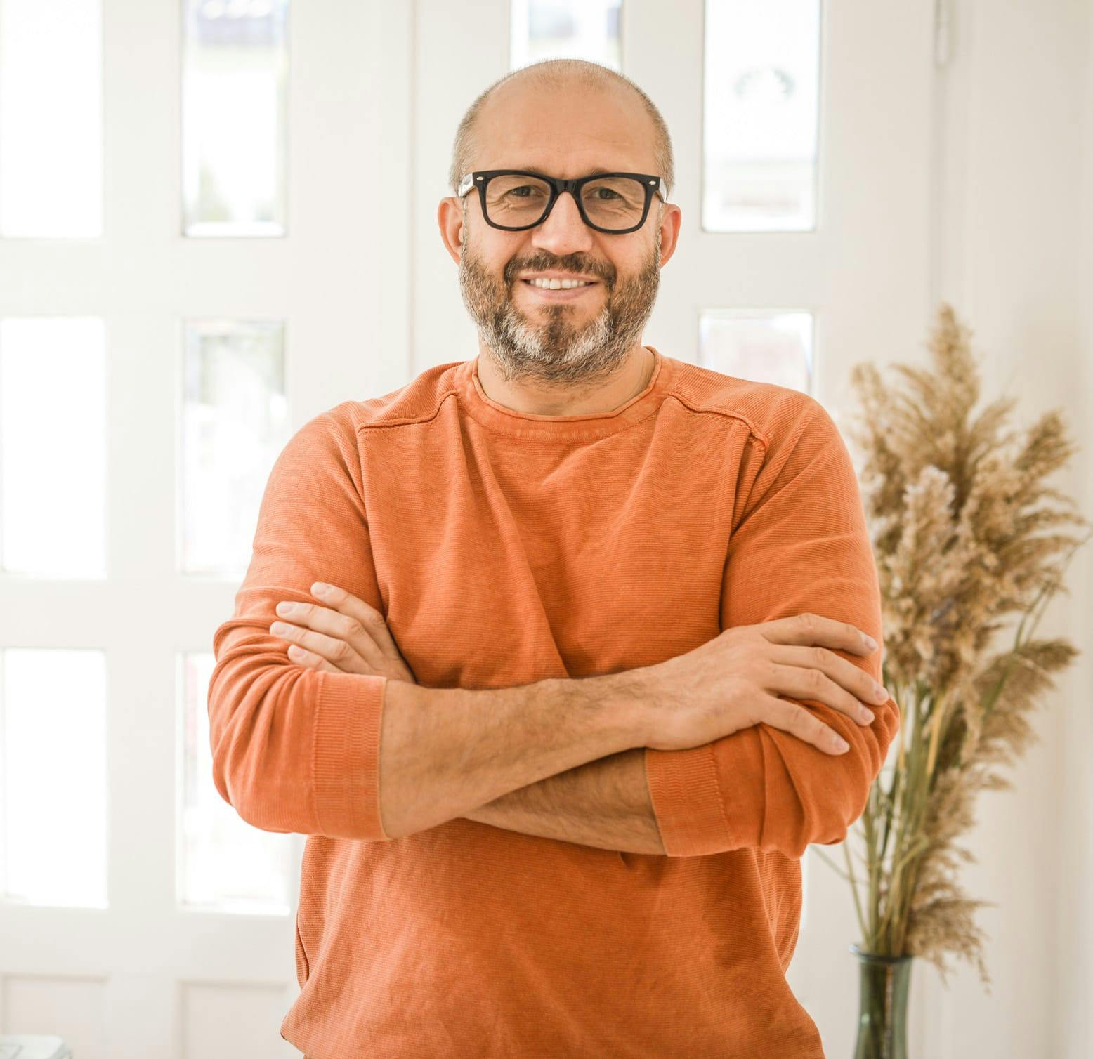 smiling man crossing his arm