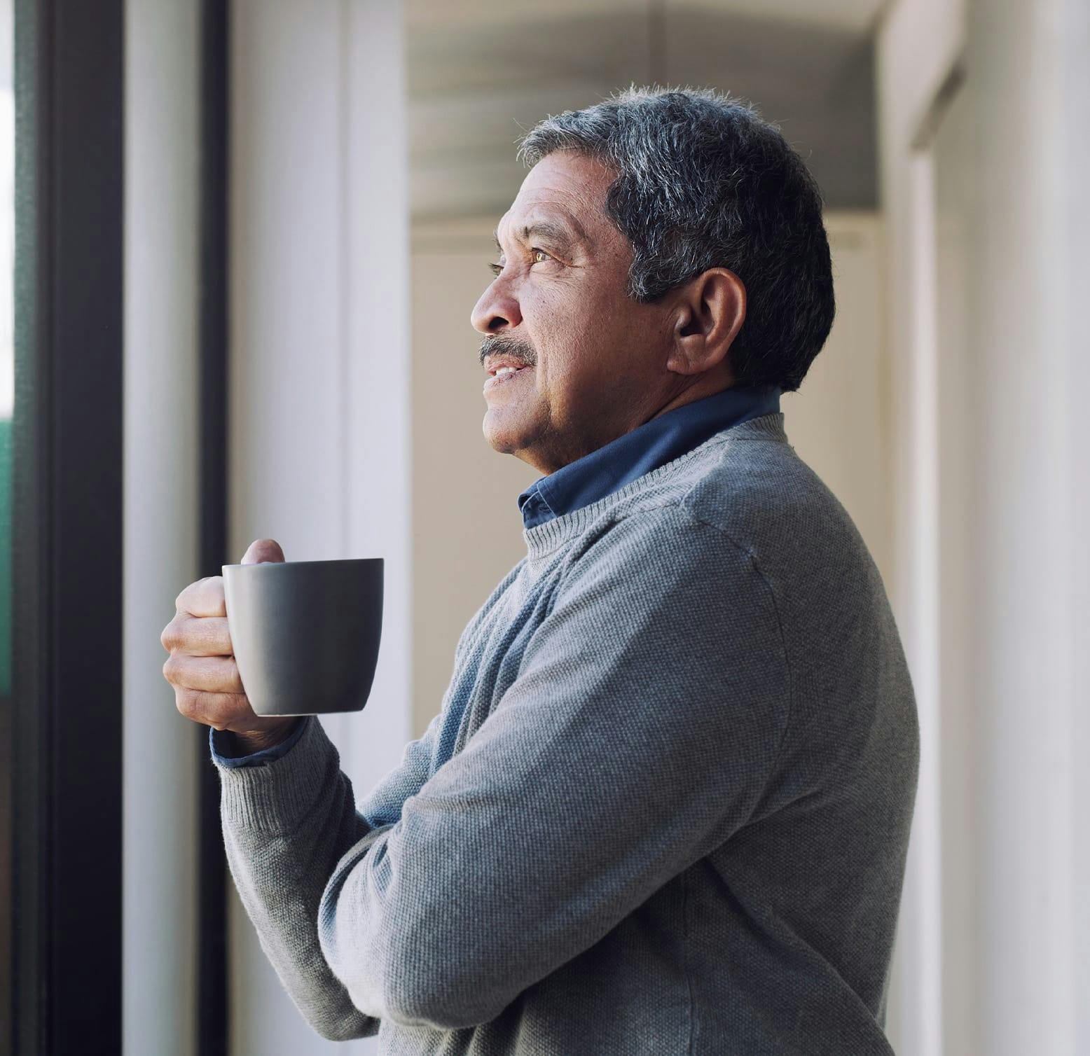 older man holding a coffee mug