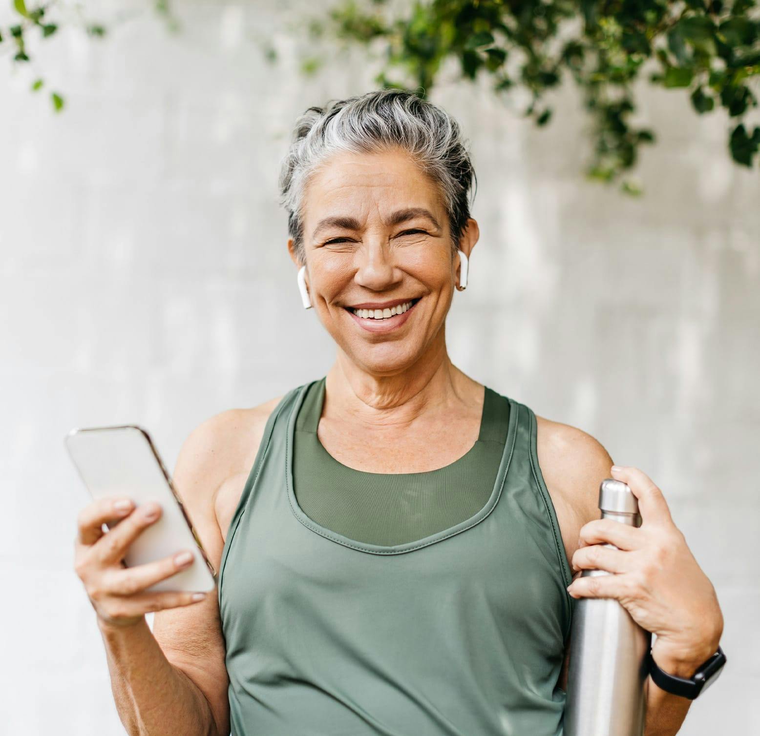 smiling older woman holding a smart phone