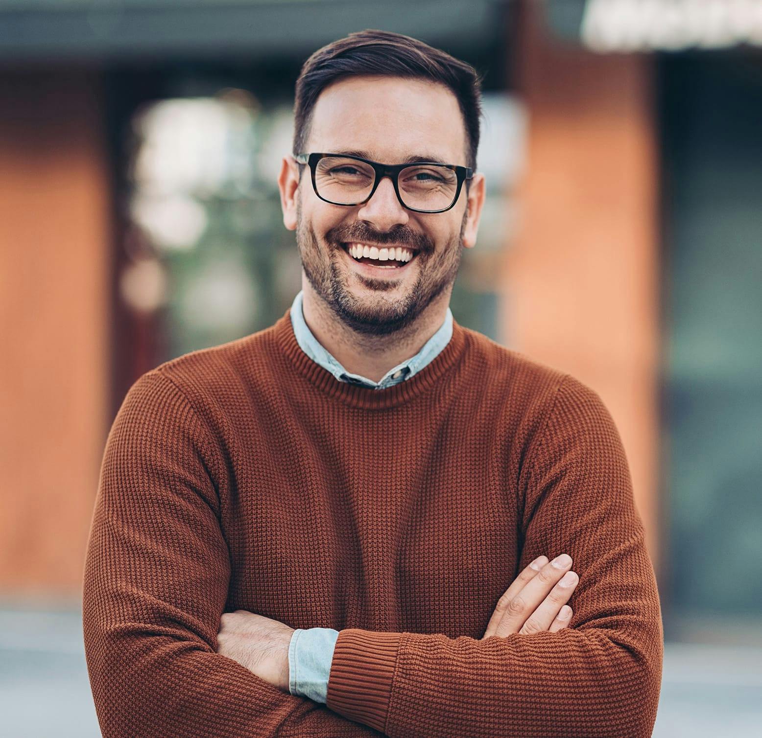 smiling man crossing his arms