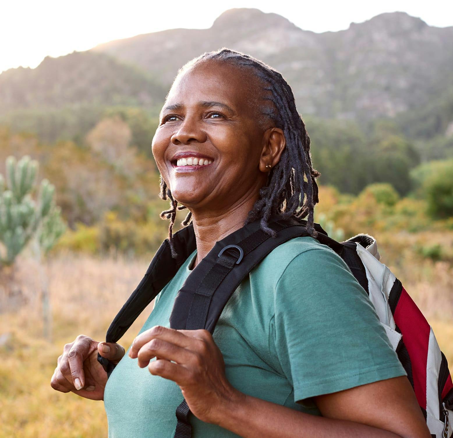 older woman walking in Joshua Tree with a backpack