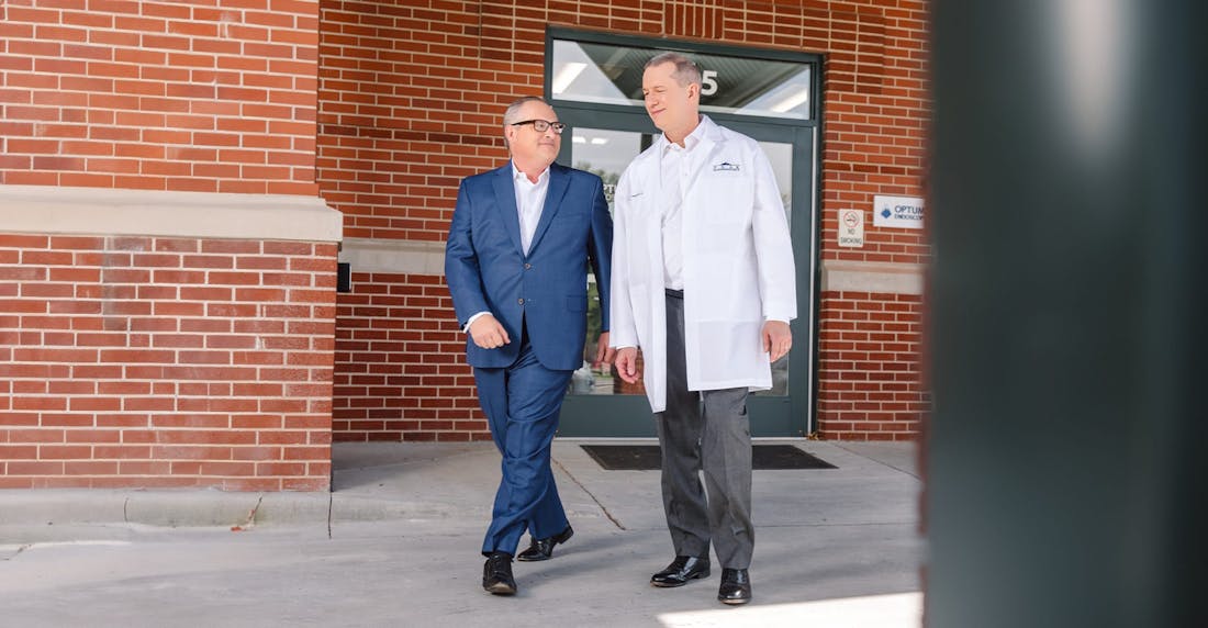 two older men walking outside
