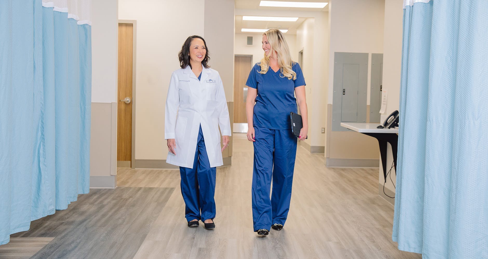 two doctors walking down an isle